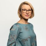 Team artra – vrouw met bril en blauwgroene blouse met bloemenprint