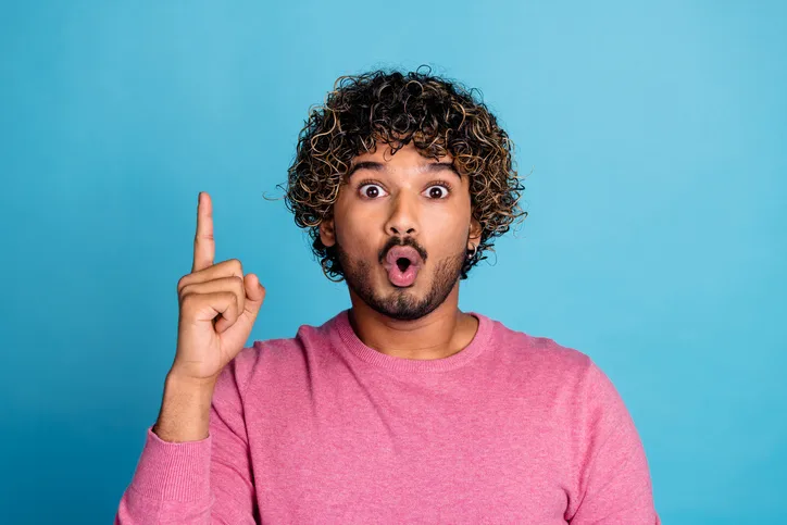 Jonge, man die omhoog wijst als symbool van het begrijpen van recruitment marketing en het belang van een sterk employer brand