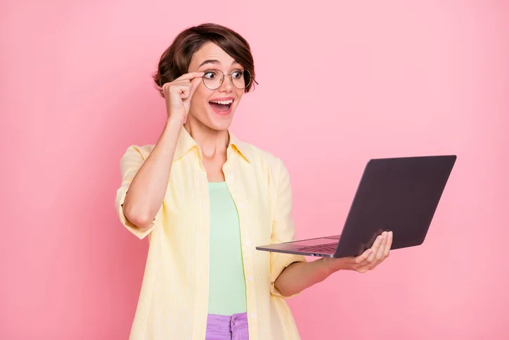 Jonge enthousiaste vrouw met laptop als symbool voor enthousiasme over werken met AI
