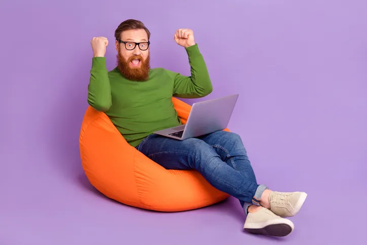 Juichende man met laptop als symbool voor modulair leren in recruitment
